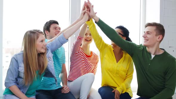 Smiling Students Making High Five Gesture