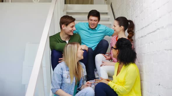 Smiling Students Sitting On Stairs And Talking 3