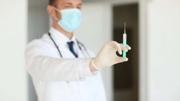 Doctor With Medical Syringe In Hands alt