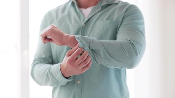 Man Unbuttoning His Sleeve At Home