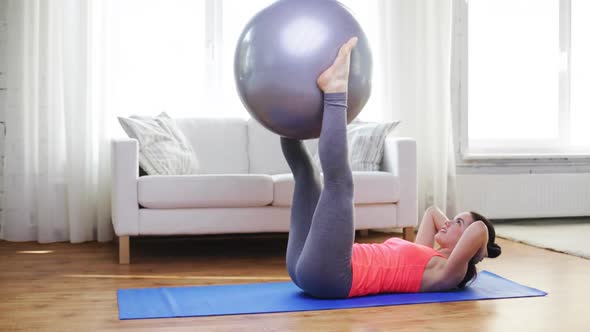 Girl Exercising With Fitness Ball At Home 2
