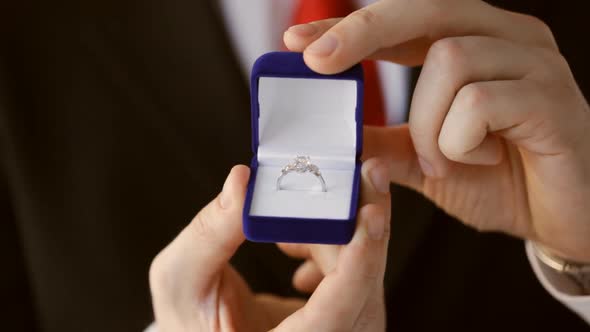 Groom Holding Wedding Ring 1