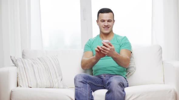 Man With Smartphone Sitting On Couch At Home 1