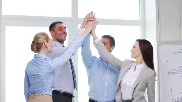 Business Team Doing High Five Gesture In Office