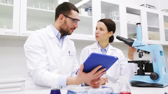 Scientists With Tablet Pc And Microscope In Lab 2 alt