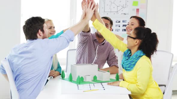 Smiling Architects Doing High Five In Office 2