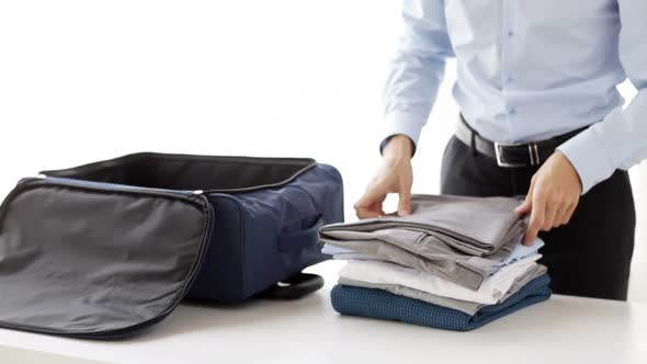 Businessman Packing Clothes Into Travel Bag 4