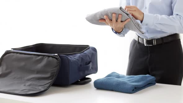 Businessman Packing Clothes Into Travel Bag 5