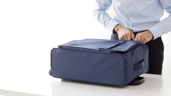 Businessman Packing Clothes Into Travel Bag 7