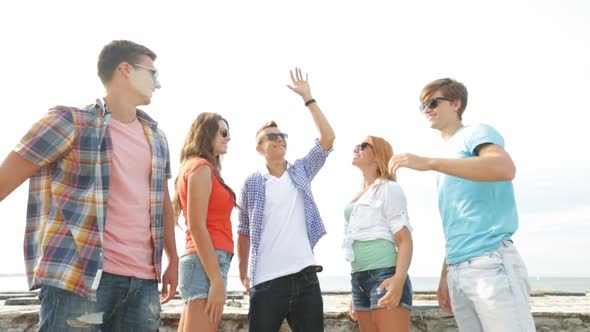 Group Of Smiling Teenagers Hanging Out Outdoors 6