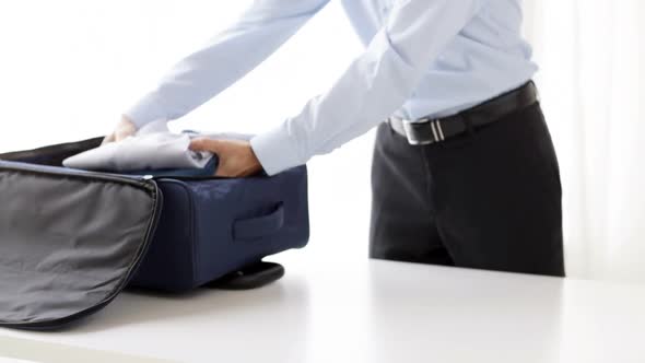 Businessman Packing Clothes Into Travel Bag 8