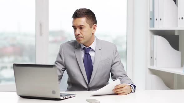 Businessman With Laptop And Papers alt