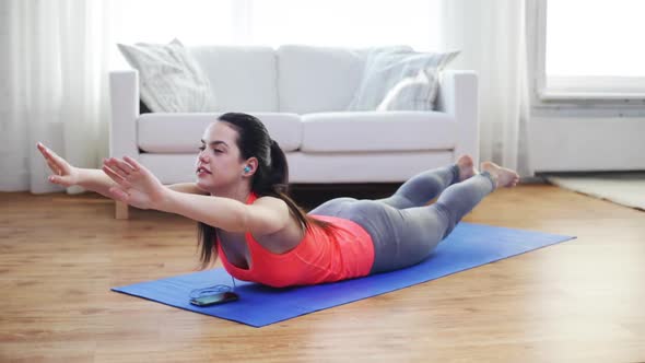 Smiling Woman With Smartphone Exercising At Home 1