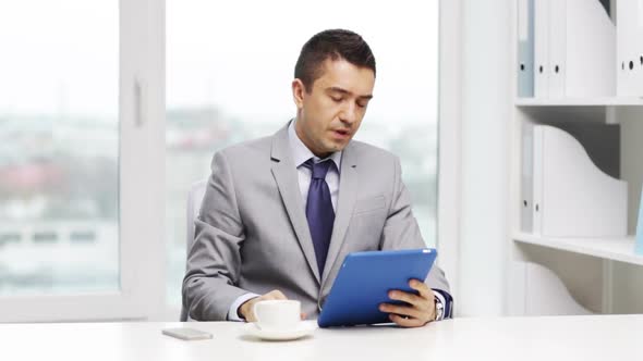 Businessman With Tablet Pc And Coffee Cup