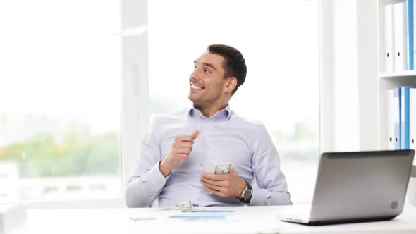 Happy Businessman With Money And Laptop In Office 2