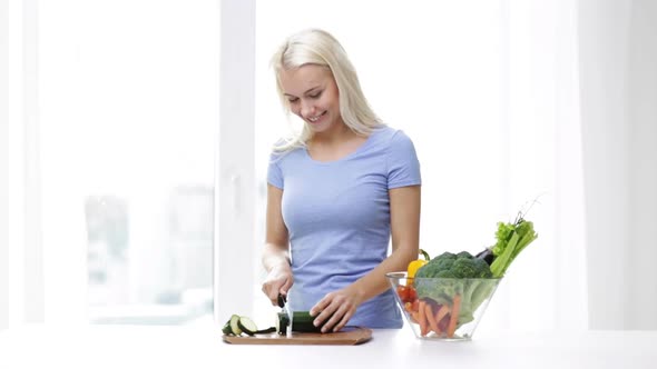 Smiling Young Woman Chopping Squash At Home 3