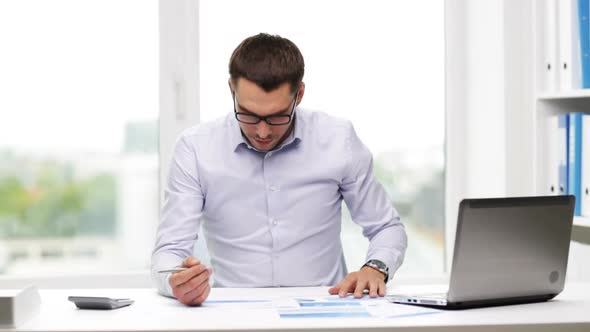 Busy Businessman With Laptop And Papers In Office 15