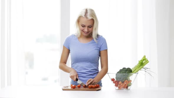 Smiling Young Woman Chopping Tomatoes At Home 1