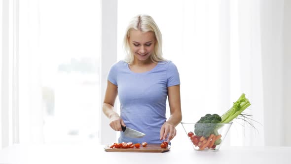 Smiling Young Woman Chopping Tomatoes At Home 2