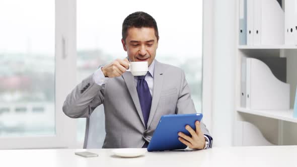 Smiling Businessman With Tablet Pc Drinking Coffee 2