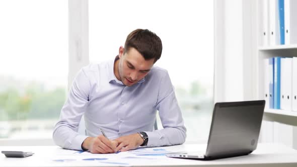 Busy Businessman With Laptop And Papers In Office 19