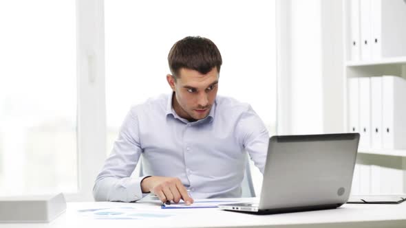 Busy Businessman With Laptop And Papers In Office 2