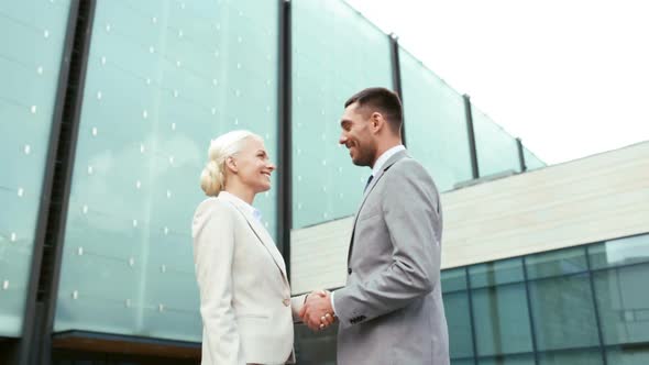 Smiling Businessmen Shaking Hands On Street 2