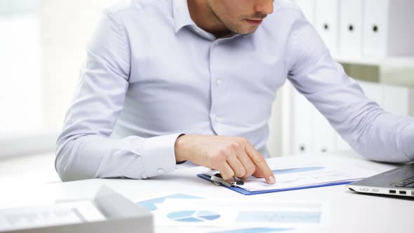Busy Businessman With Laptop And Papers In Office 21