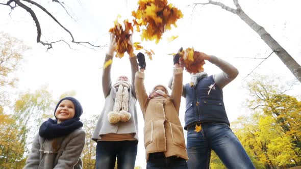 Happy Family Playing With Autumn Leaves In Park 2