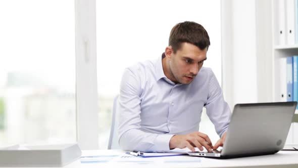 Busy Businessman With Laptop And Papers In Office 6