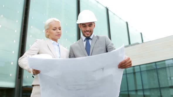 Smiling Businessmen With Blueprint And Helmets 9