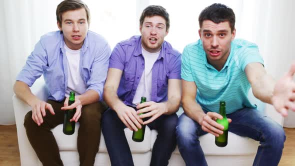 Happy Male Friends With Beer Watching Tv At Home 1