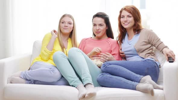 Three Smiling Teenage Girls Watching Tv At Home 2