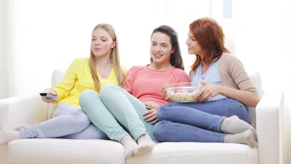 Three Smiling Teenage Girls Watching Tv At Home 4