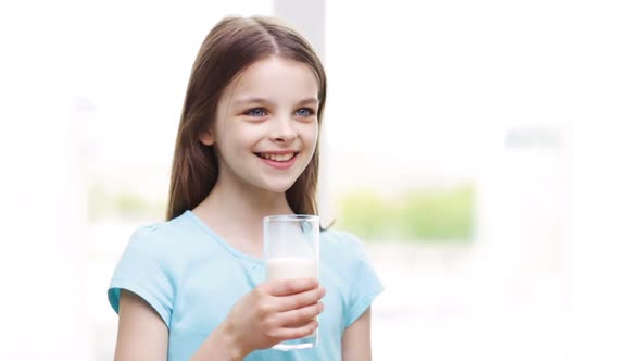 Happy Smiling Little Girl Drinking Milk At Home 4