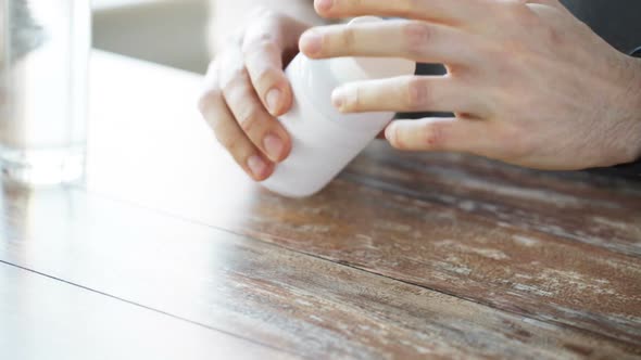 Close Up Of Man Pouring Fish Oil Capsules To Hand 4 alt