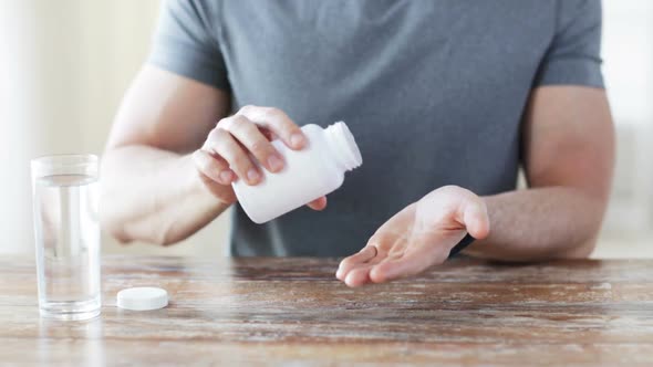 Close Up Of Man Pouring Pills From Jar To Hand 1