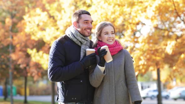 Smiling Couple With Coffee Cups In Autumn Park 1