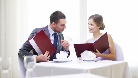 Smiling Couple With Menus At Restaurant 2