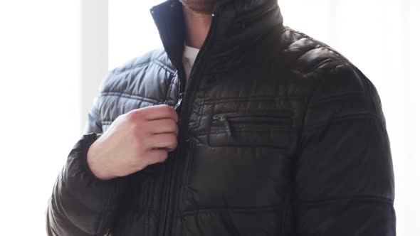 Close Up Of Man Unzipping His Black Jacket At Home 2