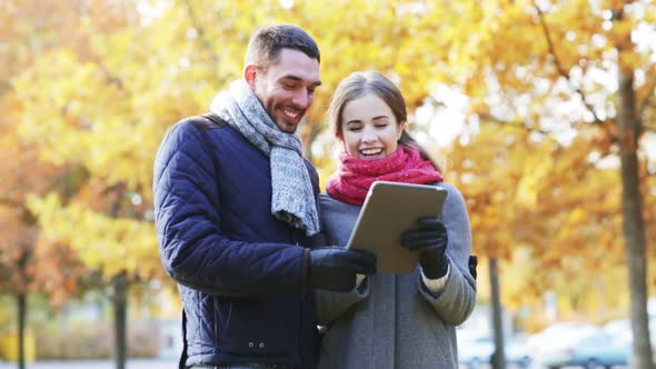 Smiling Couple With Tablet Pc In Autumn Park 1