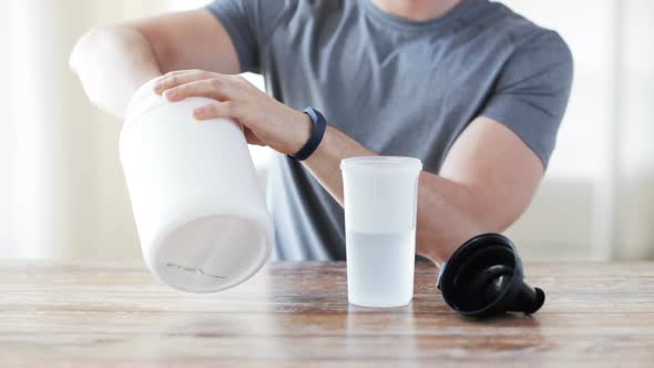 Close Up Of Man With Protein Shake Bottle And Jar 1