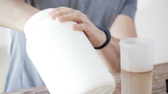 Close Up Of Man With Protein Shake Bottle And Jar 6