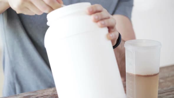 Close Up Of Man With Protein Shake Bottle And Jar 7