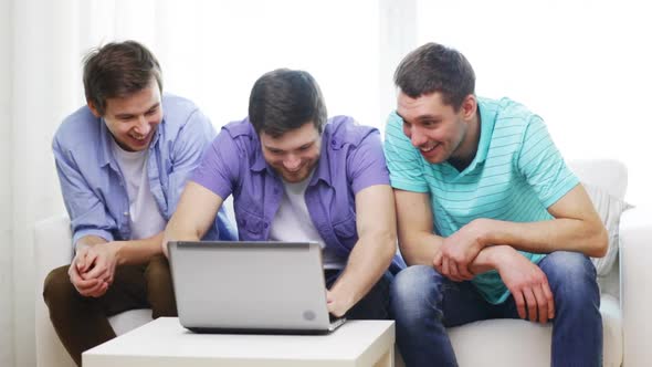 Smiling Friends With Laptop Computer At Home 1