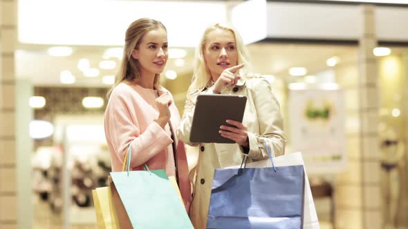 Happy Young Women With Tablet Pc And Shopping Bags 5