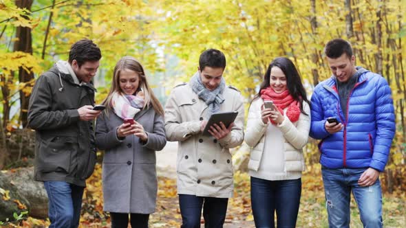 Smiling Friends With Smartphones And Tablet Pc 2