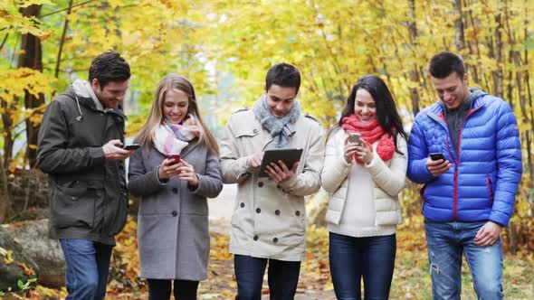 Smiling Friends With Smartphones And Tablet Pc 3