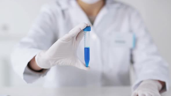 Close Up Of Scientist With Full Beaker In Lab 3 alt