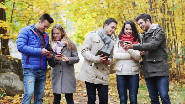 Smiling Friends With Smartphones And Tablet Pc 6